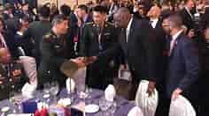 US Defense Secretary Lloyd Austin greets Chinese counterpart at summit after Beijing blocks talks